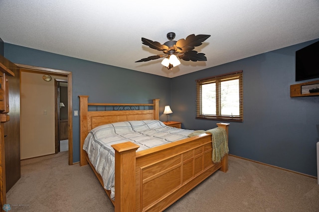 bedroom featuring light colored carpet and ceiling fan