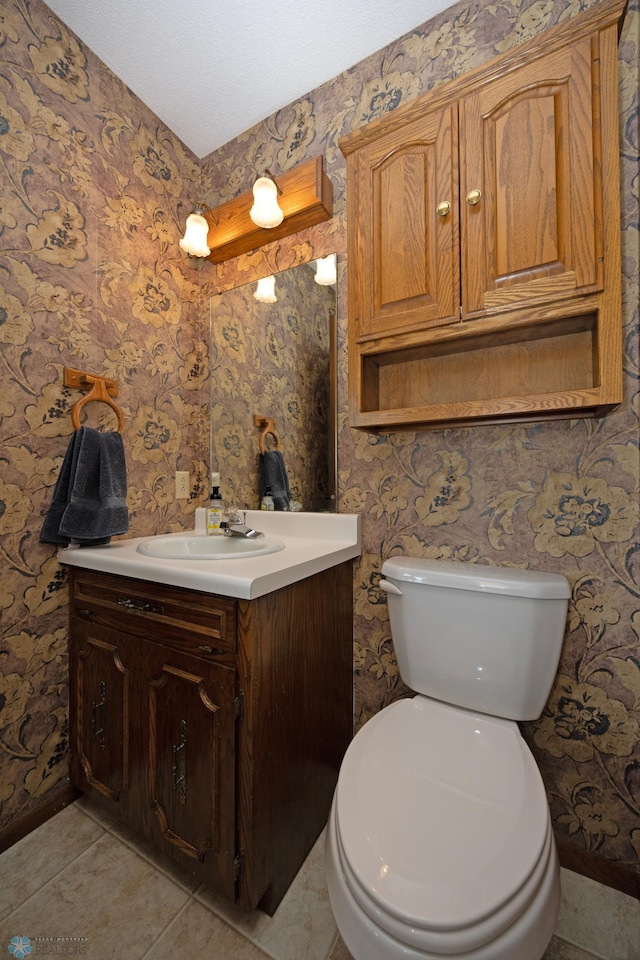 bathroom with vanity, tile patterned flooring, and toilet