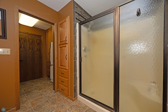 bathroom featuring a shower with shower door