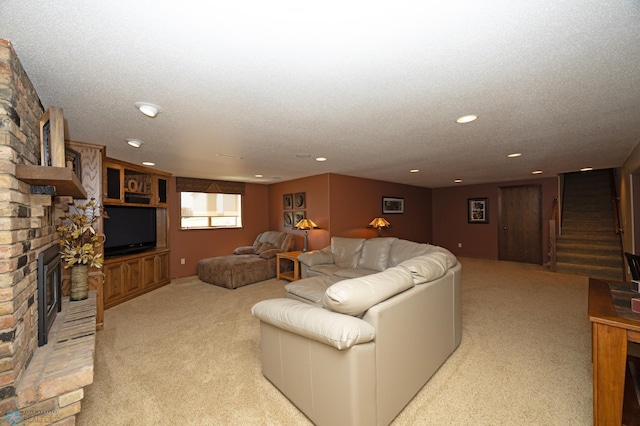 carpeted living room featuring a brick fireplace and a textured ceiling