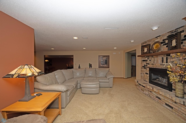 carpeted living room featuring a brick fireplace and a textured ceiling