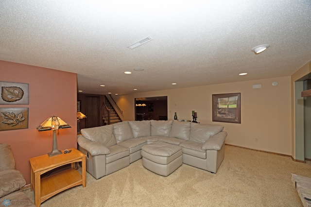 carpeted living room with a textured ceiling