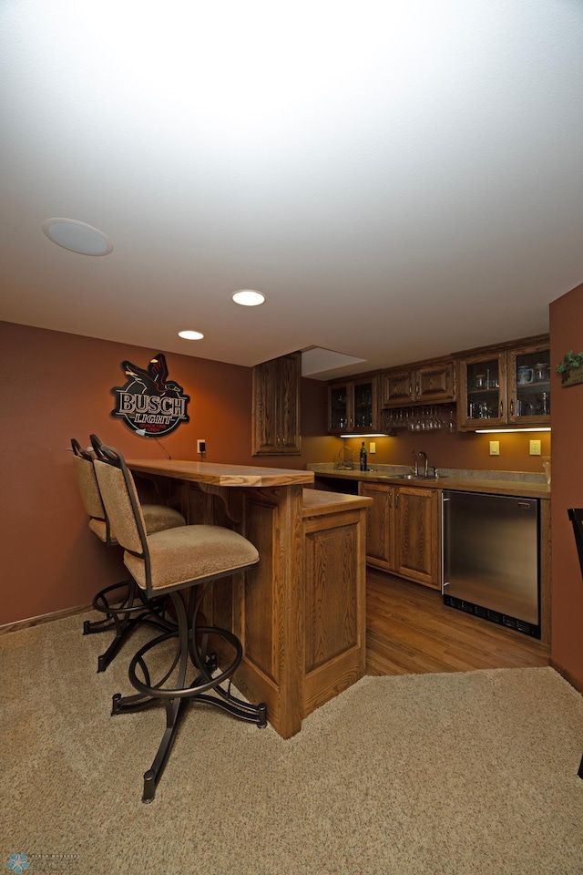 bar featuring dishwashing machine and sink