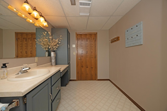 bathroom with vanity and a paneled ceiling