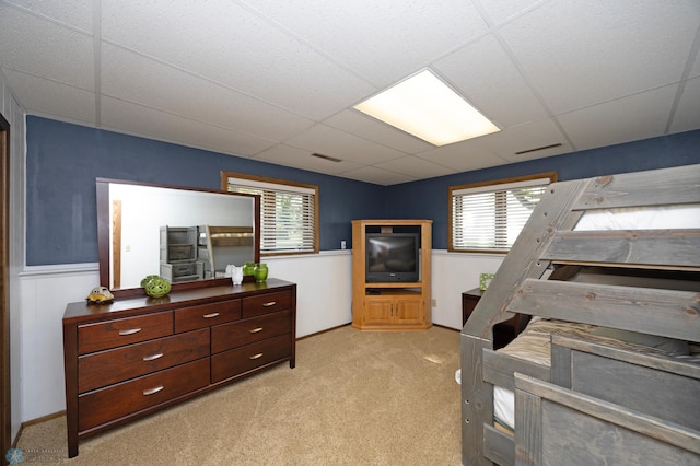 carpeted bedroom with a drop ceiling