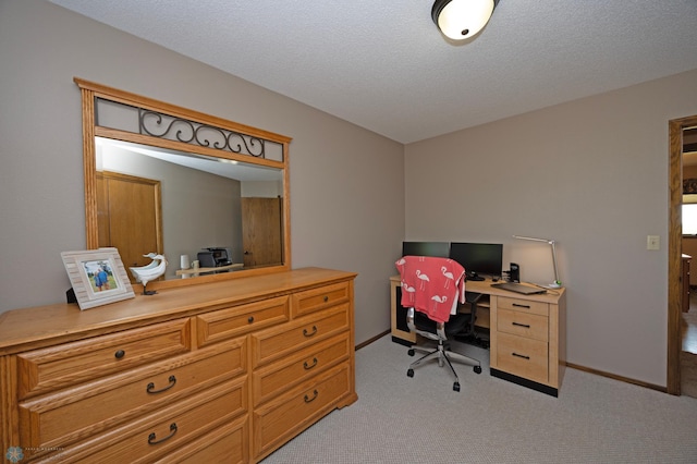 carpeted home office with a textured ceiling