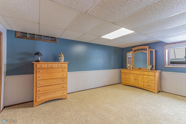 carpeted bedroom with a paneled ceiling