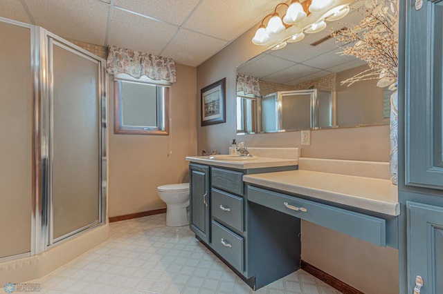 bathroom with vanity, a paneled ceiling, and a shower with shower door