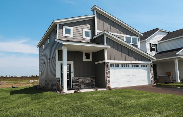 view of front facade featuring a front yard and a garage