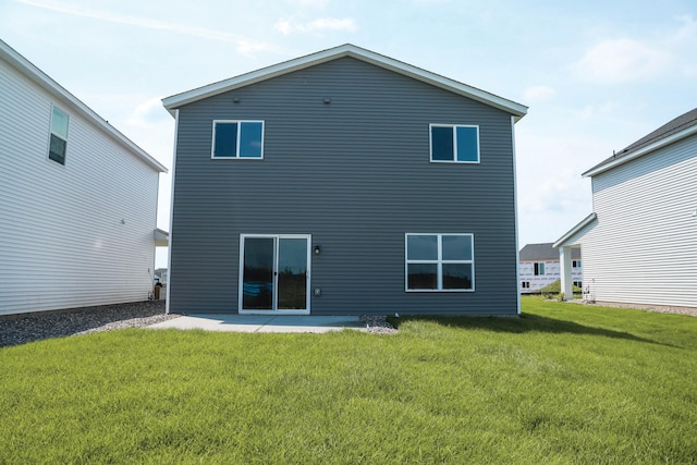 rear view of house featuring a lawn and a patio area