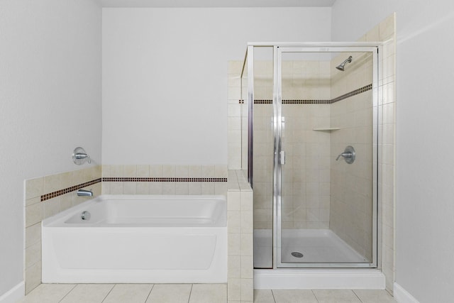 bathroom featuring tile patterned flooring and shower with separate bathtub