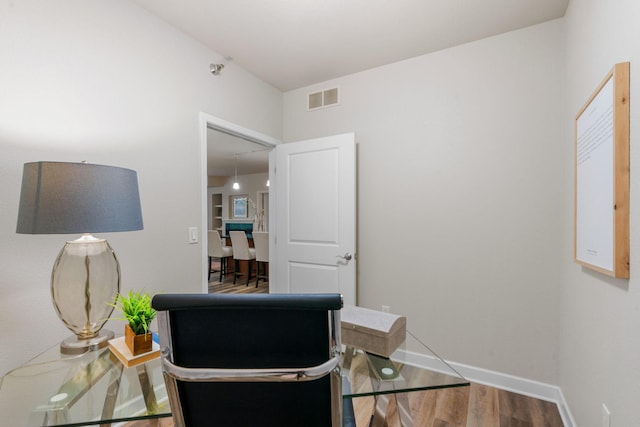 home office with hardwood / wood-style flooring