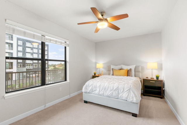 bedroom featuring ceiling fan and carpet