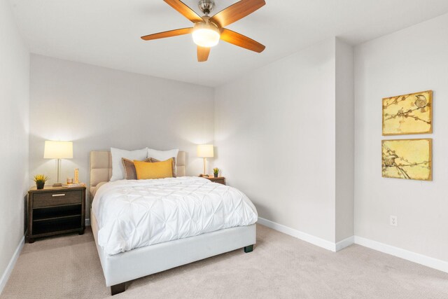 bedroom with light carpet and ceiling fan