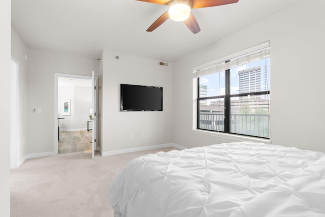 bedroom featuring ceiling fan and light carpet