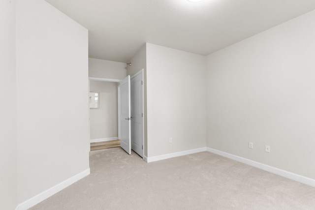 unfurnished bedroom with light colored carpet