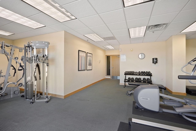 exercise room with carpet flooring and a paneled ceiling