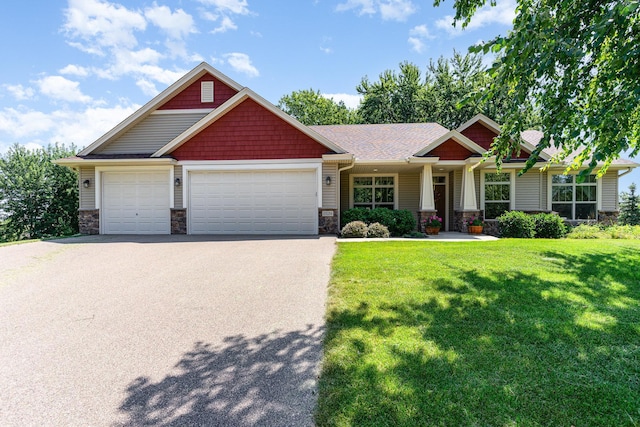 craftsman inspired home featuring a garage and a front yard