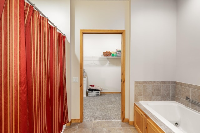 bathroom featuring tile patterned flooring and a bath