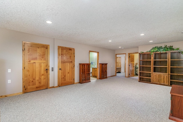 basement with carpet and a textured ceiling