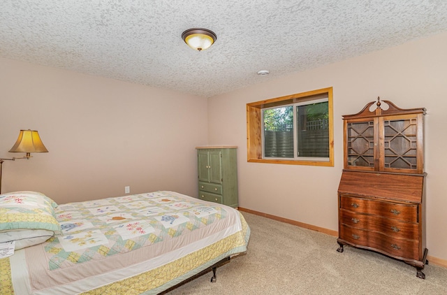 carpeted bedroom with a textured ceiling