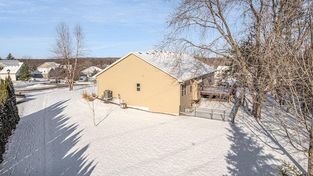 snow covered property featuring cooling unit