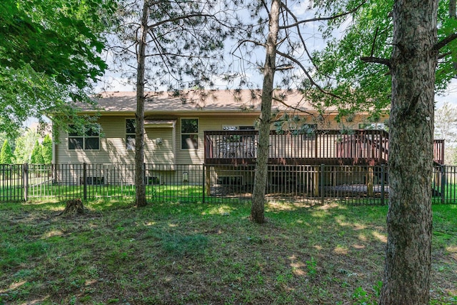 back of house with a wooden deck and a lawn