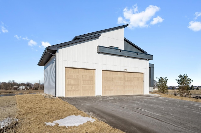 view of side of property featuring solar panels and a garage