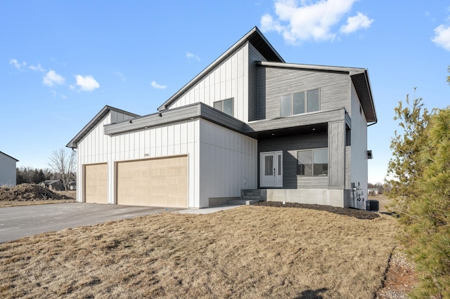 view of front of property featuring central AC and a garage