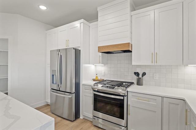 kitchen with decorative backsplash, light wood-type flooring, white cabinetry, and stainless steel appliances