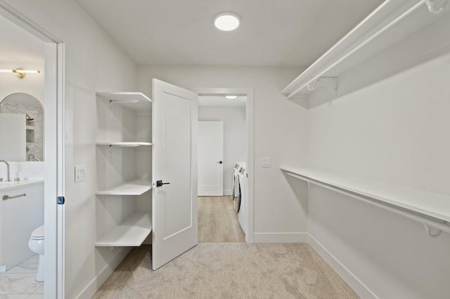 spacious closet featuring washing machine and dryer