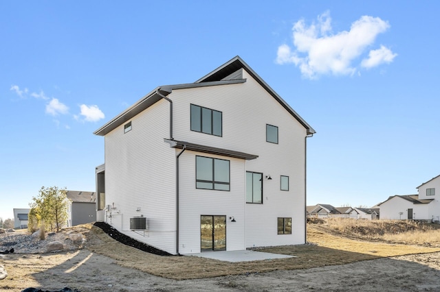 rear view of property featuring a patio area