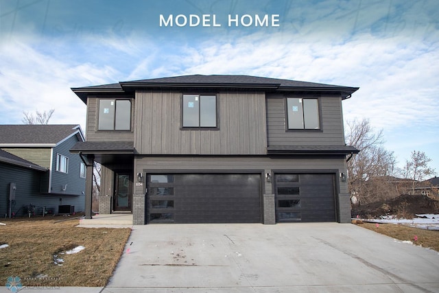 view of front of home featuring a front lawn, a garage, and central AC