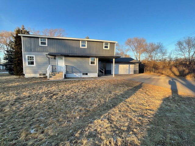 back of property with a garage