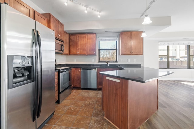 kitchen featuring sink, decorative light fixtures, and stainless steel appliances