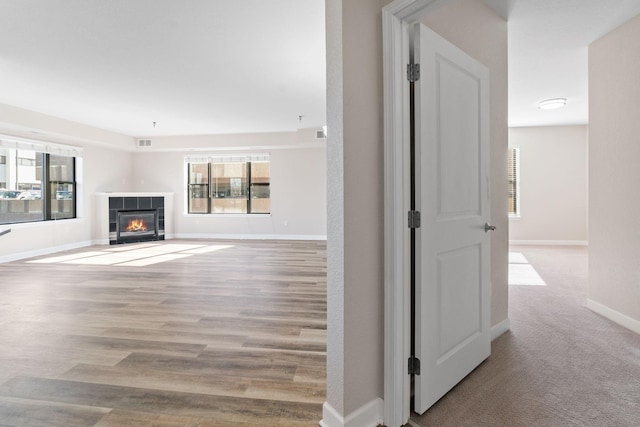 unfurnished living room with a fireplace and light hardwood / wood-style flooring