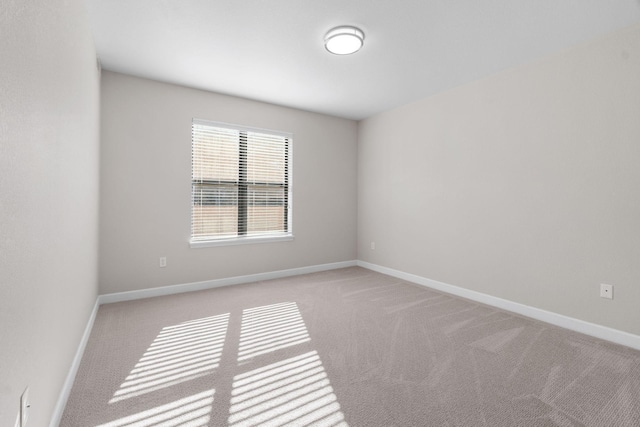 unfurnished room featuring light carpet