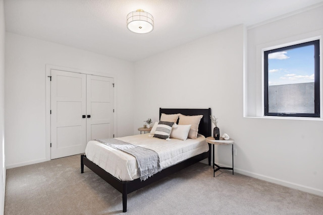 bedroom with light colored carpet and a closet