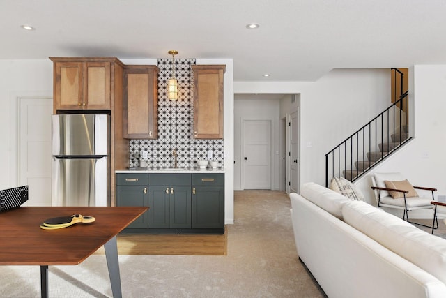 kitchen with stainless steel fridge, tasteful backsplash, and sink