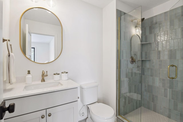 bathroom with vanity, an enclosed shower, and toilet