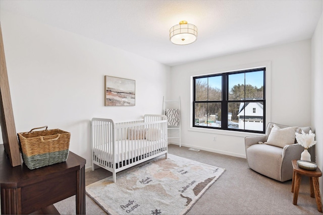 bedroom with carpet flooring and a crib