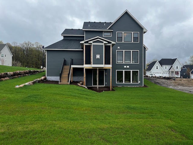 rear view of property with a wooden deck and a yard