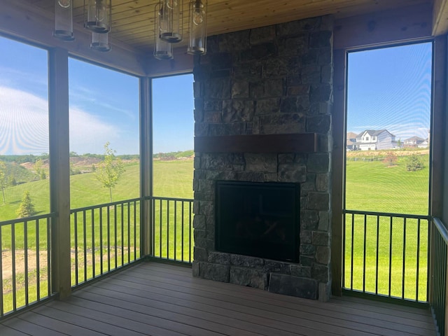 wooden deck with a stone fireplace