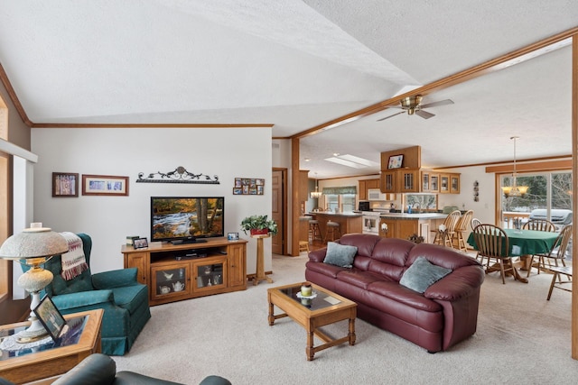 living room with lofted ceiling, ornamental molding, light colored carpet, and a textured ceiling