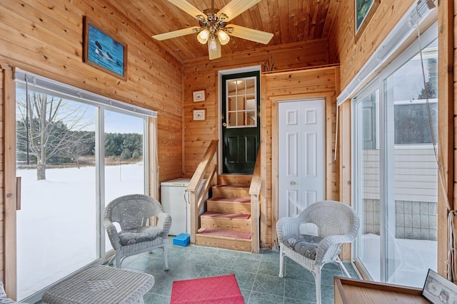 sunroom featuring wooden ceiling and ceiling fan