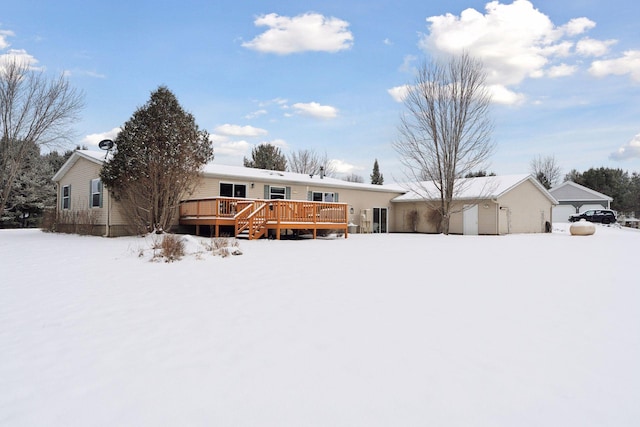 snow covered property featuring a wooden deck