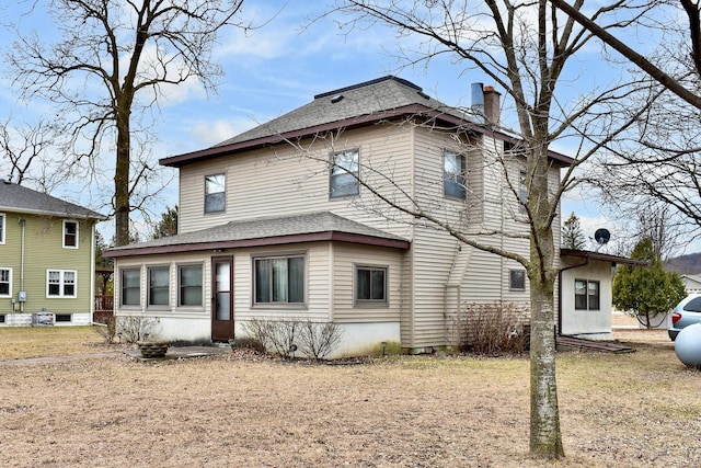 back of house with a lawn