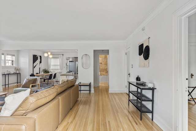 living room featuring light hardwood / wood-style flooring and ornamental molding