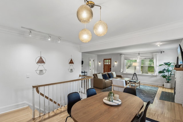 dining area featuring hardwood / wood-style flooring and ornamental molding