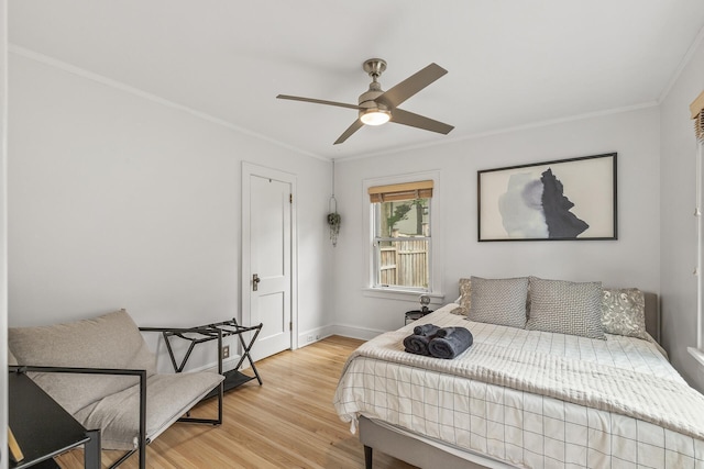 bedroom featuring ceiling fan, light wood-type flooring, and ornamental molding